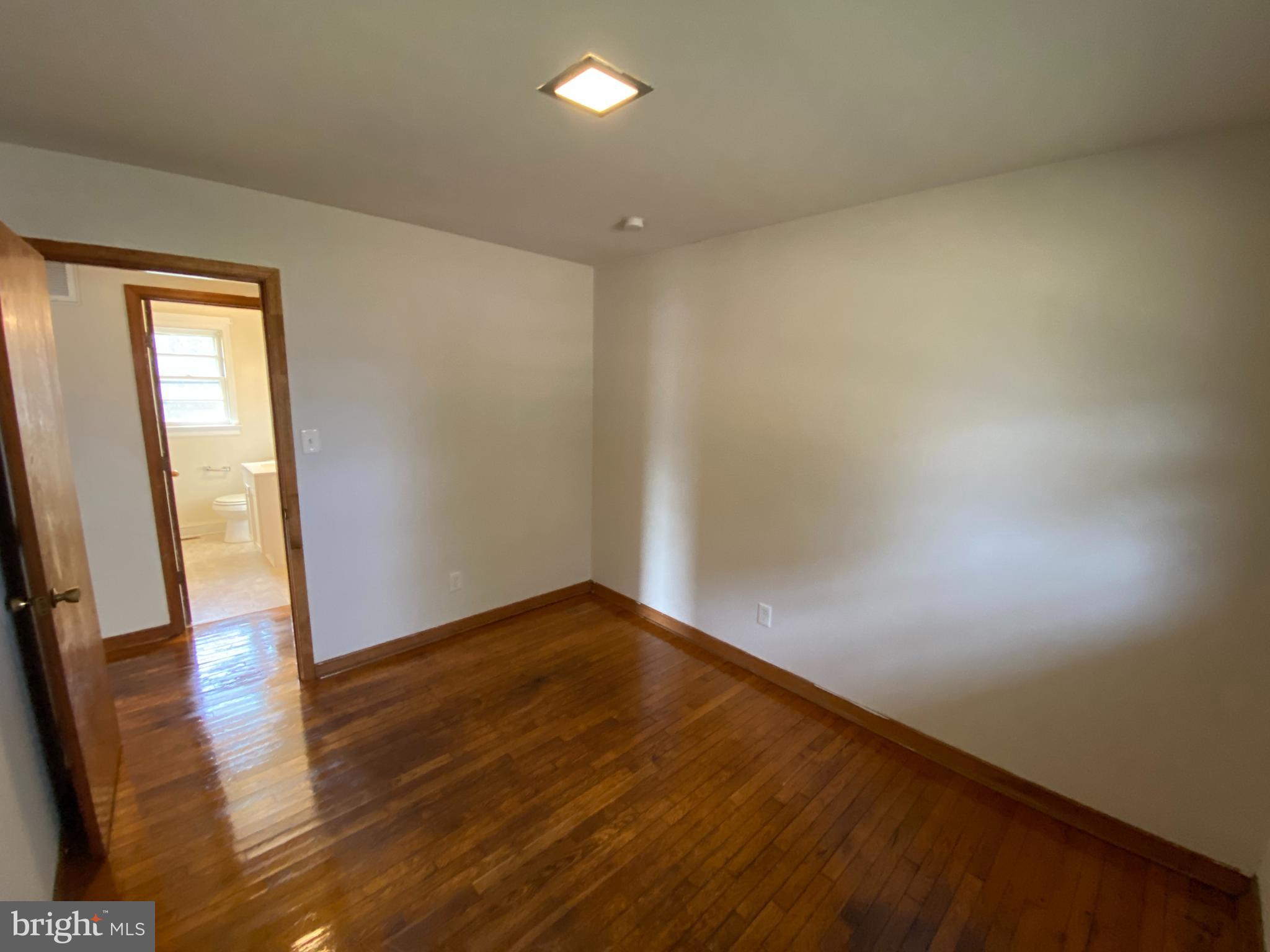 10514 Robert E Lee Drive Spotsylvania, VA 22551 - Photo 13 of 28 an empty room with wooden floor and mirror