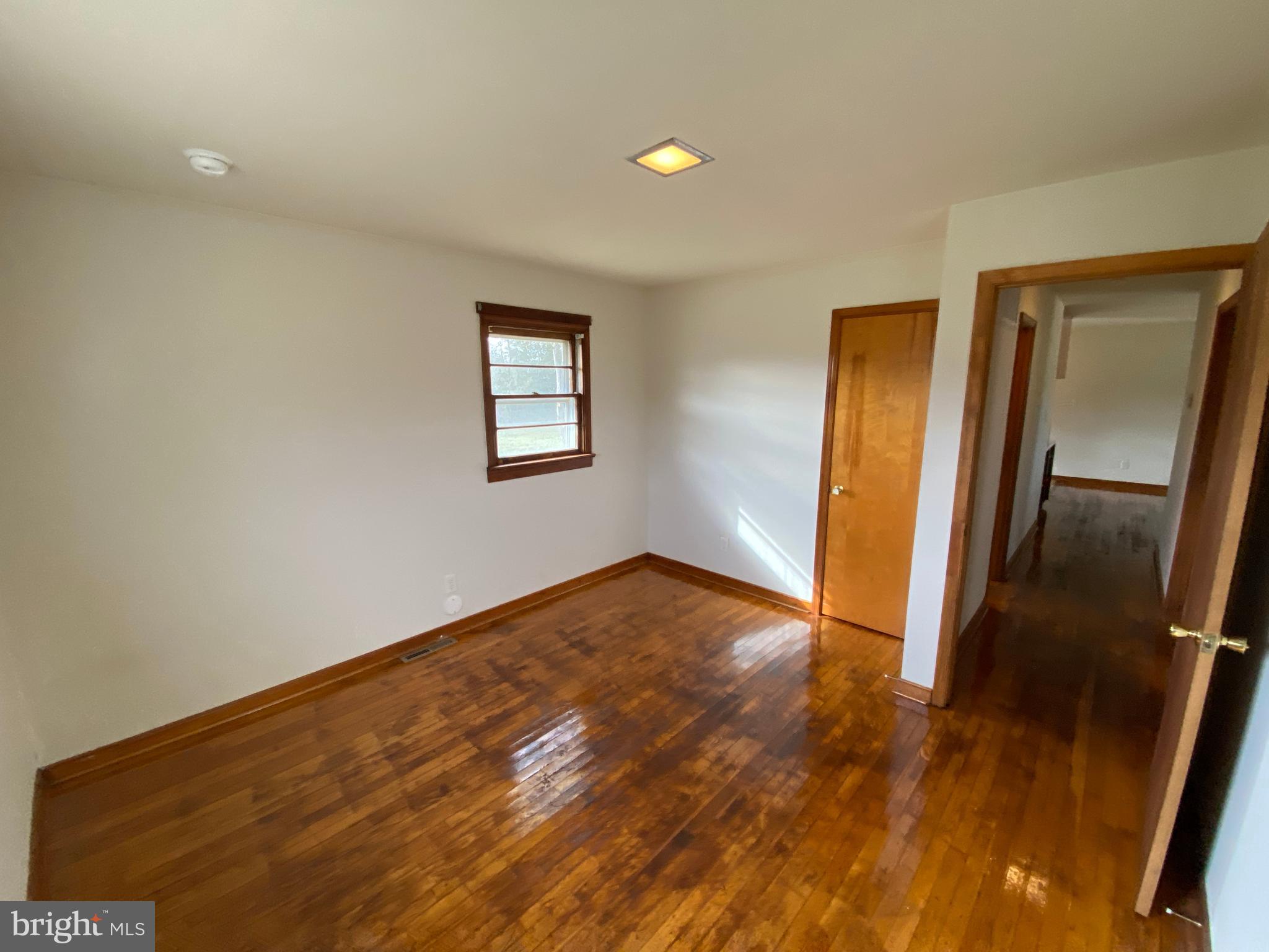 10514 Robert E Lee Drive Spotsylvania, VA 22551 - Photo 19 of 28 a view of an empty room with wooden floor and a window