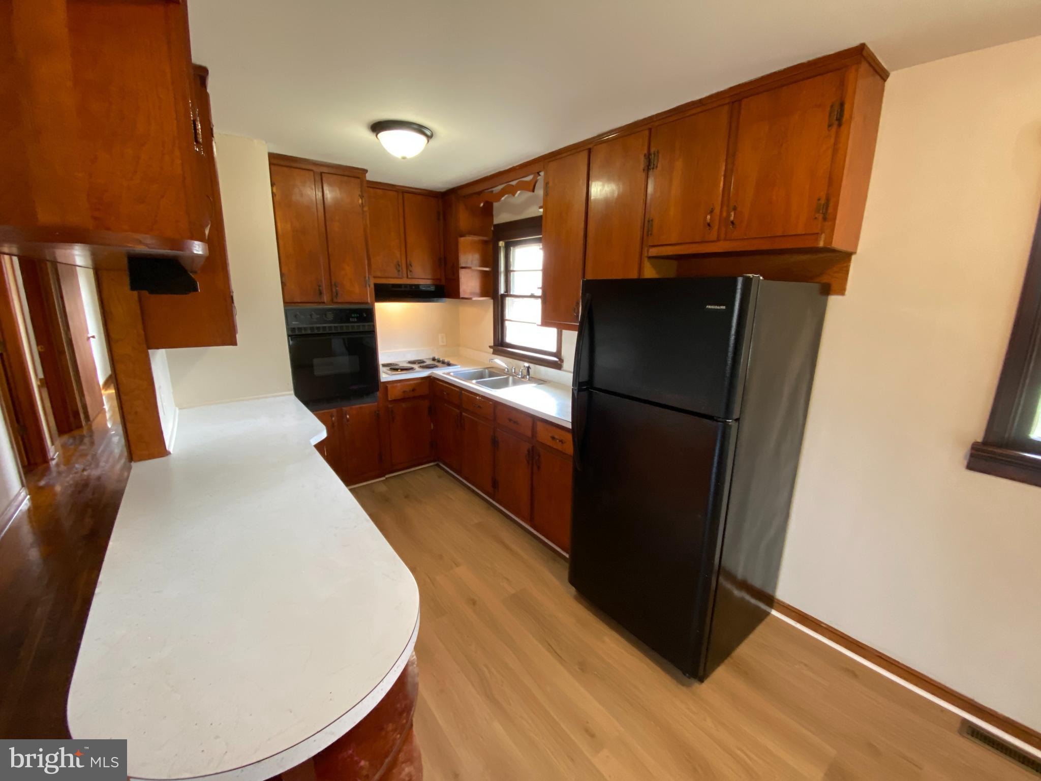 10514 Robert E Lee Drive Spotsylvania, VA 22551 - Photo 7 of 28 a kitchen with a refrigerator and wooden floor