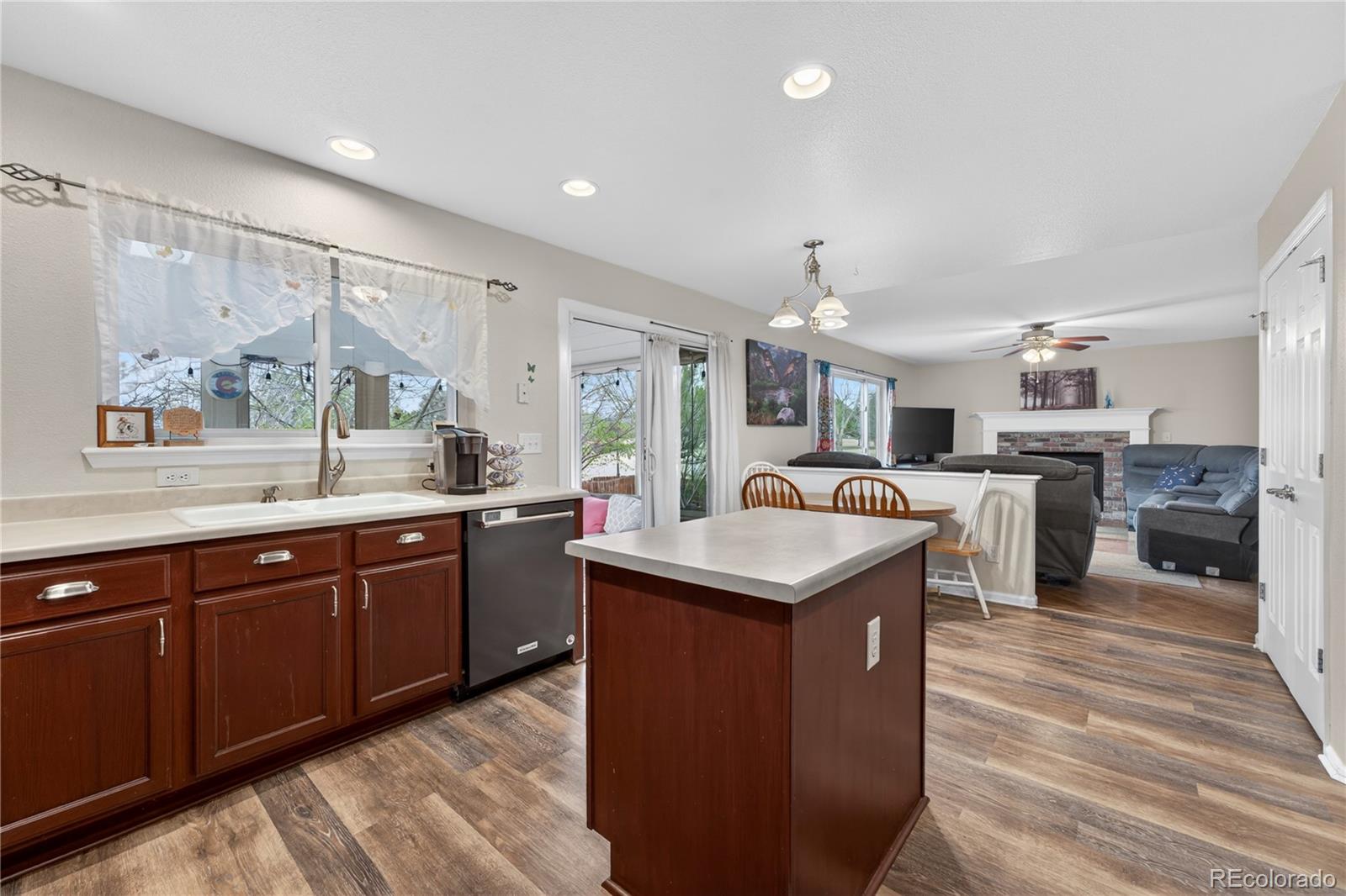 6289 Viewpoint Avenue Firestone, CO 80504 - Photo 11 of 45 a kitchen with granite countertop a sink and cabinets