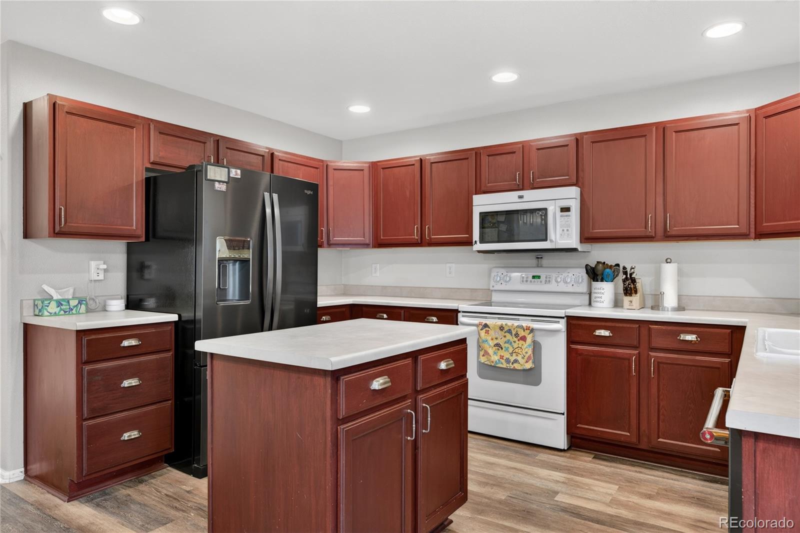 6289 Viewpoint Avenue Firestone, CO 80504 - Photo 14 of 45 a kitchen with stainless steel appliances granite countertop a refrigerator stove a sink and a microwave