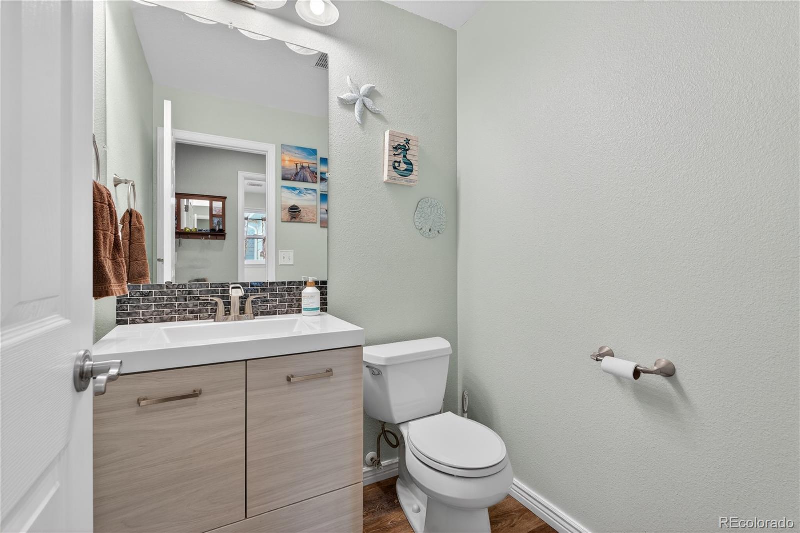 6289 Viewpoint Avenue Firestone, CO 80504 - Photo 18 of 45 a bathroom with a sink toilet and mirror