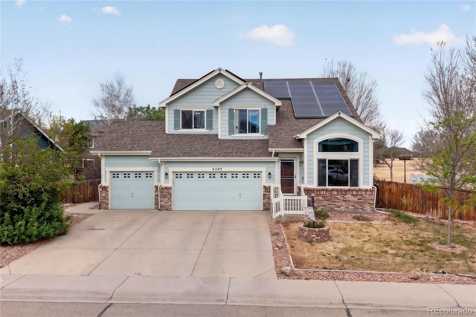 6289 Viewpoint Avenue Firestone, CO 80504 - Photo 2 of 45 a view of a white house with a yard and large trees