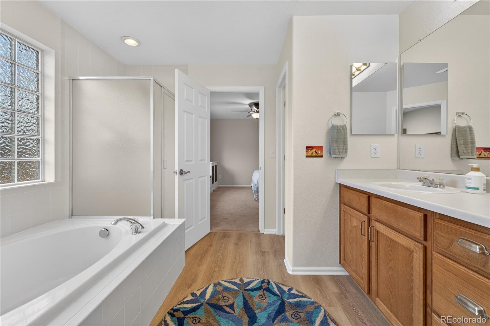 6289 Viewpoint Avenue Firestone, CO 80504 - Photo 24 of 45 a bathroom with a tub sink and mirror