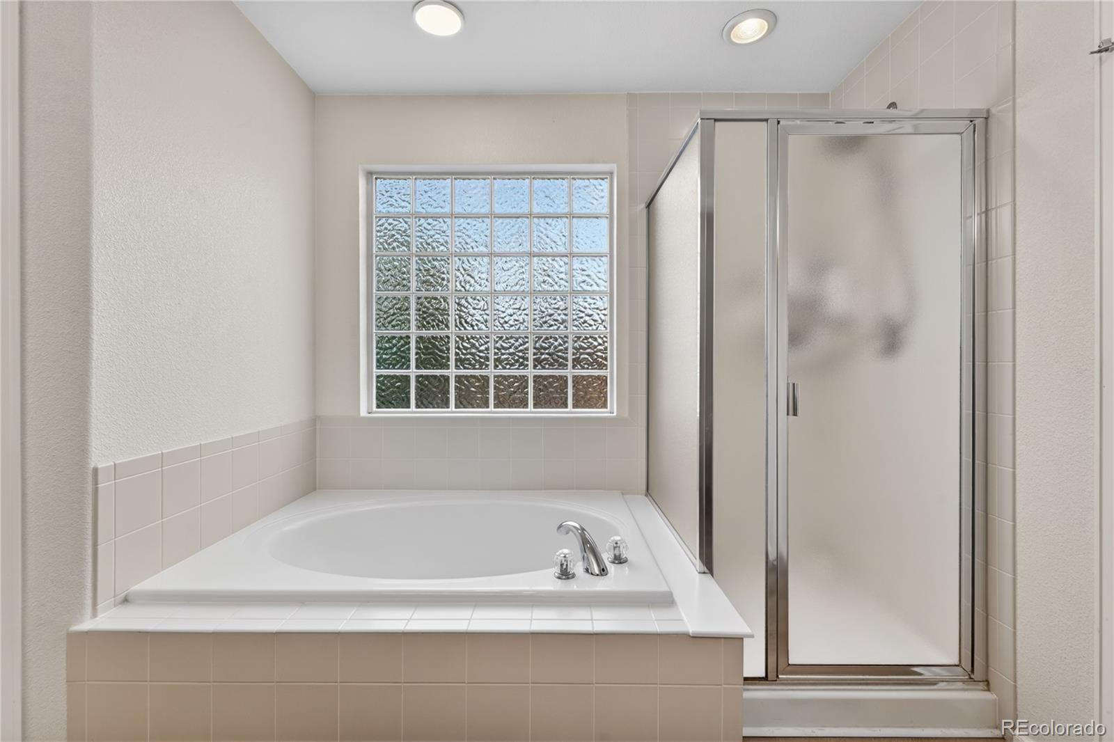 6289 Viewpoint Avenue Firestone, CO 80504 - Photo 25 of 45 a bathroom with a bathtub and a shower