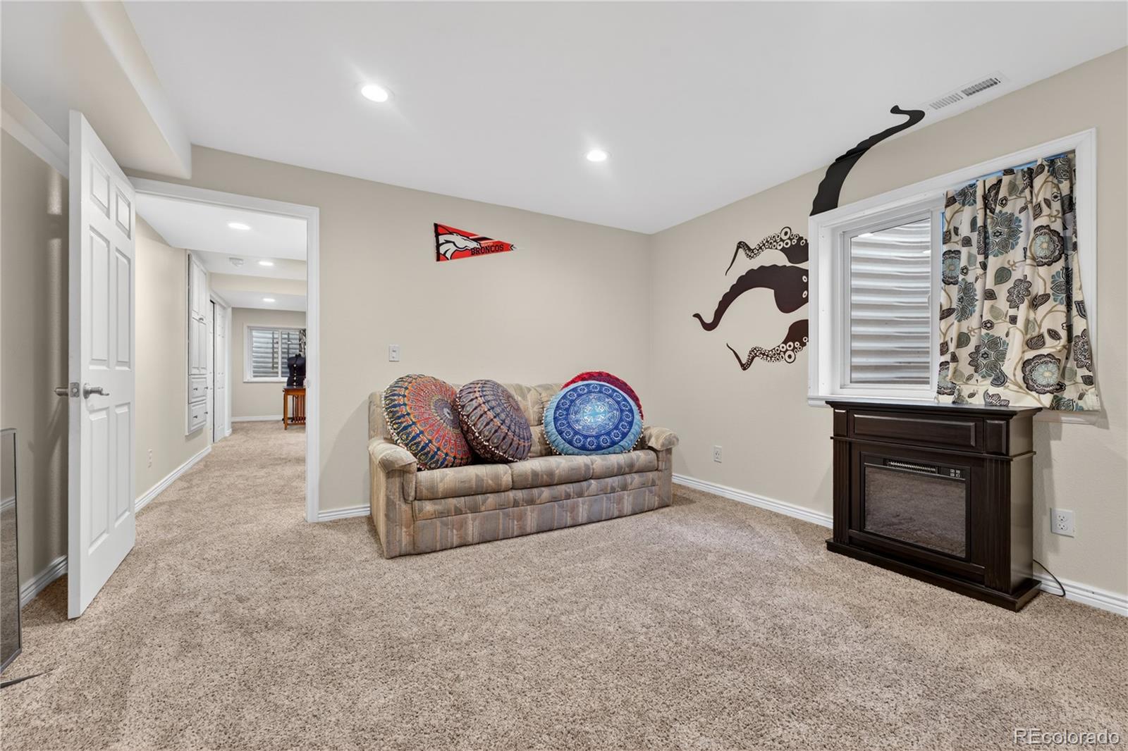 6289 Viewpoint Avenue Firestone, CO 80504 - Photo 33 of 45 a living room with furniture and a fireplace