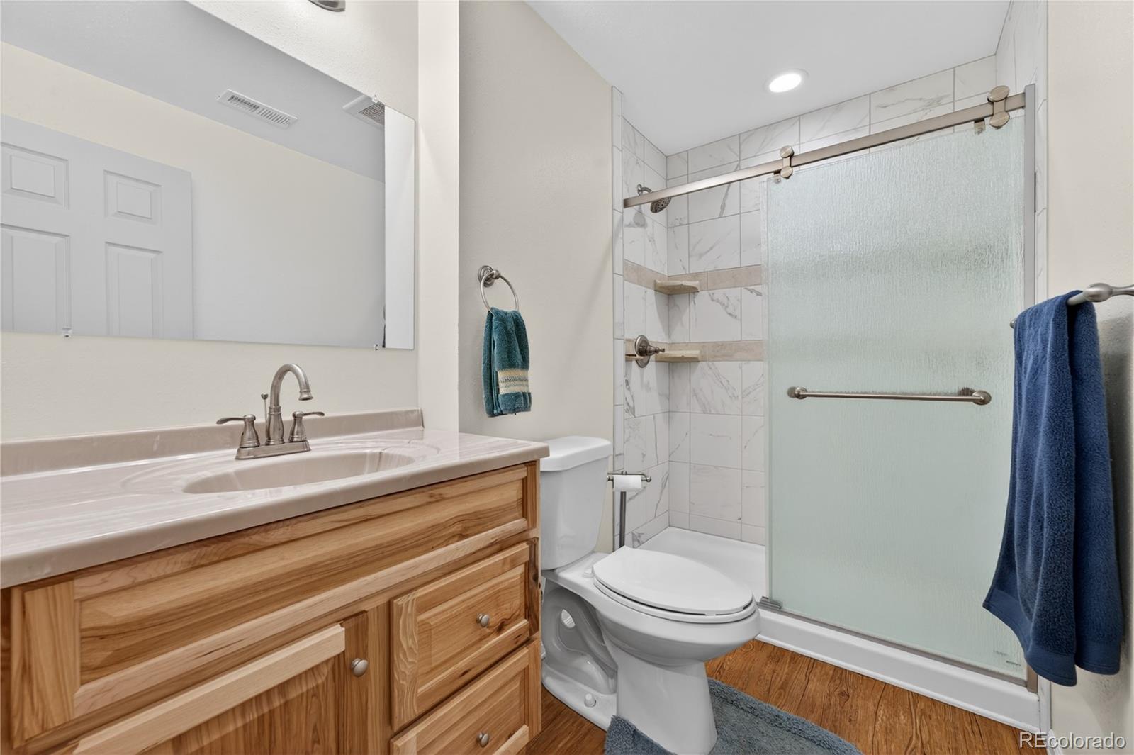 6289 Viewpoint Avenue Firestone, CO 80504 - Photo 34 of 45 a bathroom with a sink a toilet and a shower