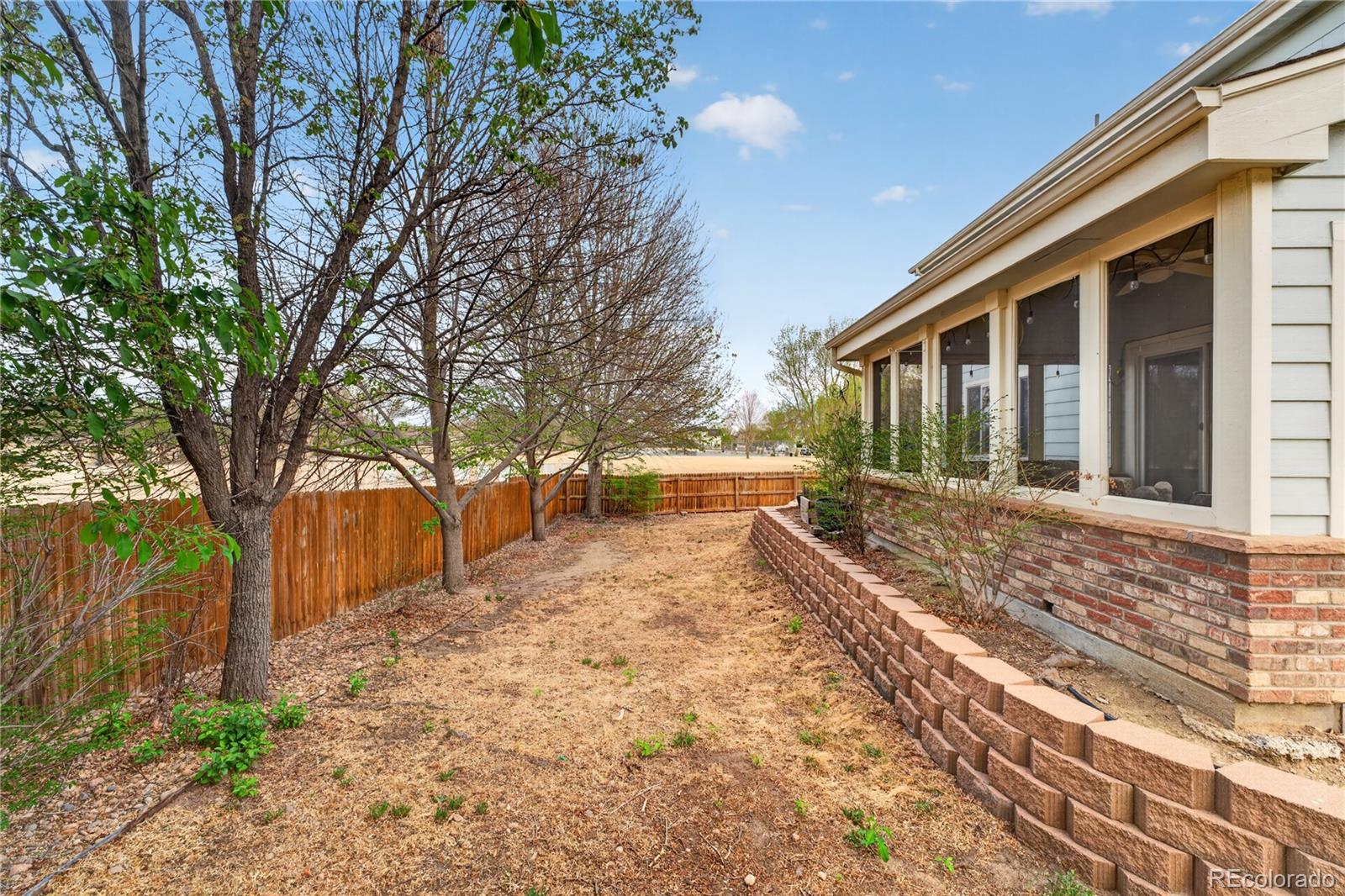 6289 Viewpoint Avenue Firestone, CO 80504 - Photo 36 of 45 a view of house with backyard and tree