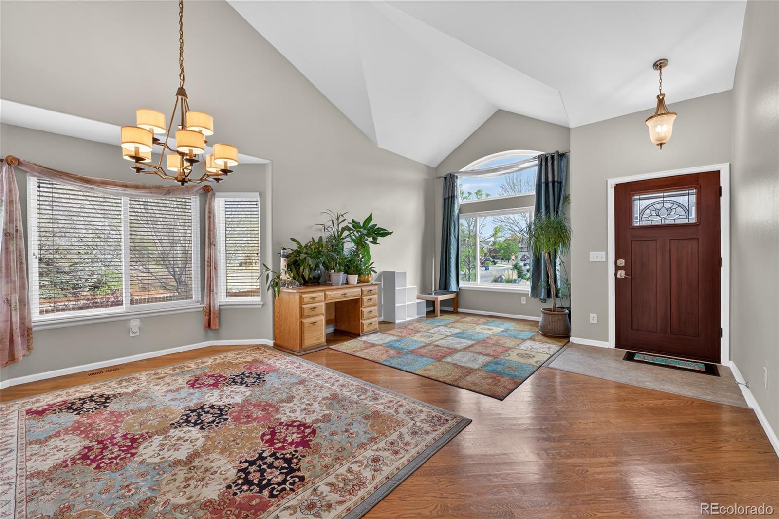 6289 Viewpoint Avenue Firestone, CO 80504 - Photo 4 of 45 a very nice looking room with a large window and chandelier