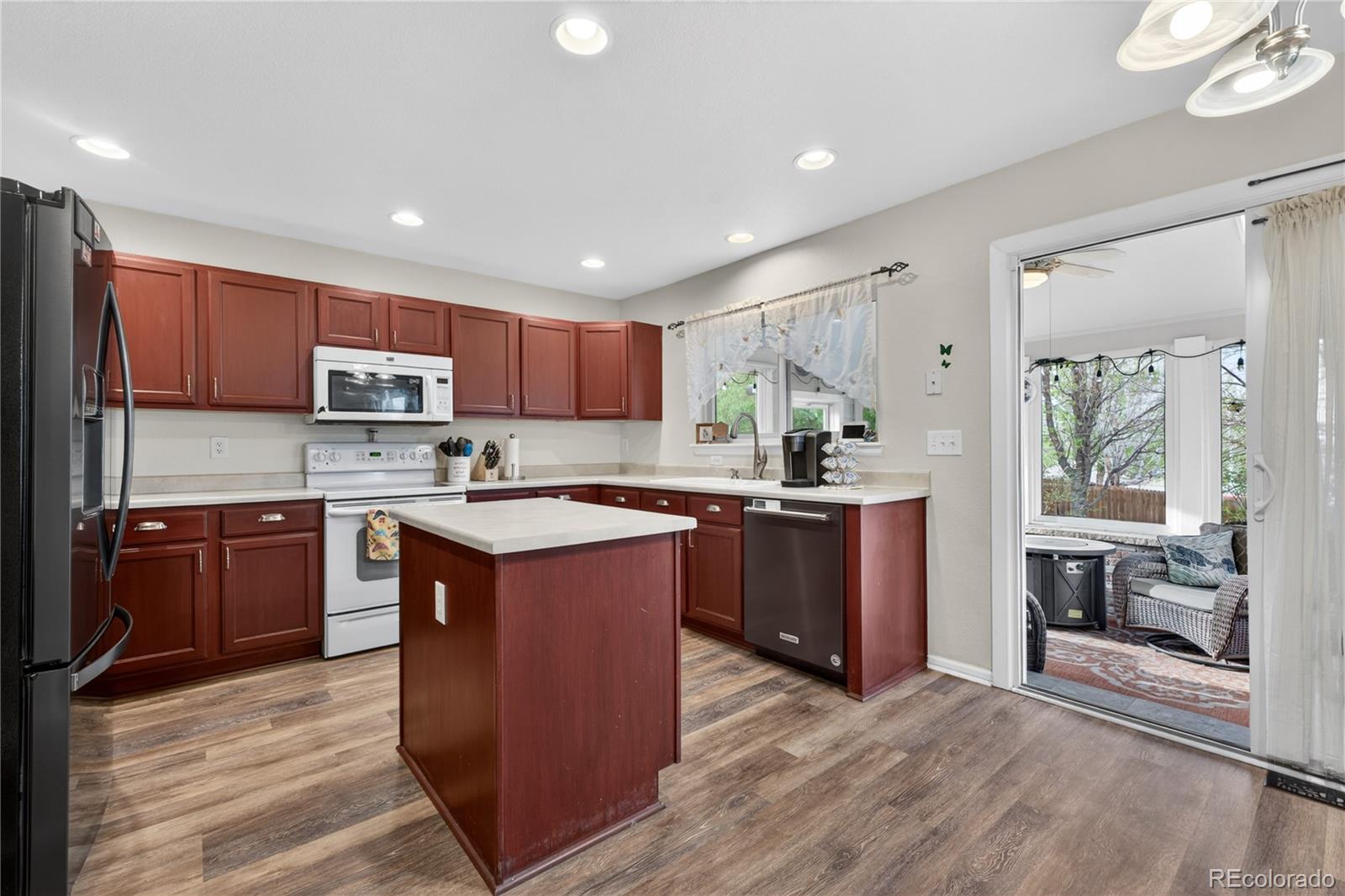 6289 Viewpoint Avenue Firestone, CO 80504 - Photo 9 of 45 a kitchen with wooden cabinets and a sink