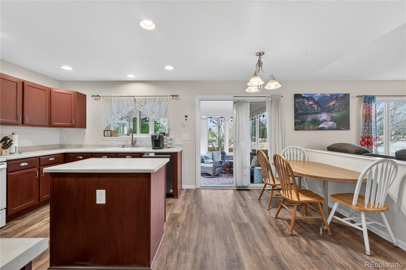 6289 Viewpoint Avenue Firestone, CO 80504 - Photo 10 of 45 a kitchen with kitchen island granite countertop wooden floors and stainless steel appliances