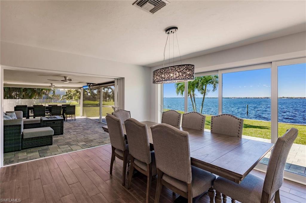 138 Riverview Road Fort Myers, FL 33905 - Photo 19 of 50 Dining area with dark wood-type flooring, a water view, visible vents, and a ceiling fan