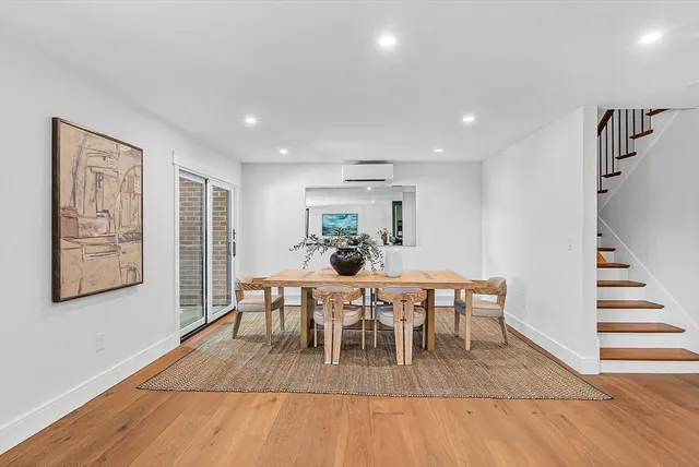 a view of a dining room with furniture wooden floor and window