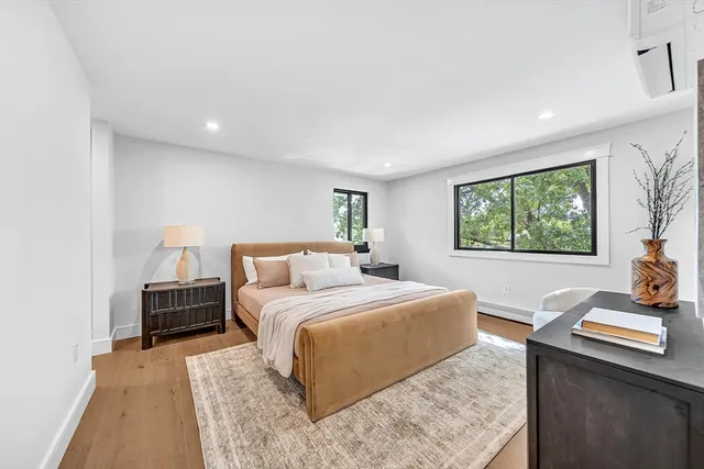 a bedroom with a large bed and a window