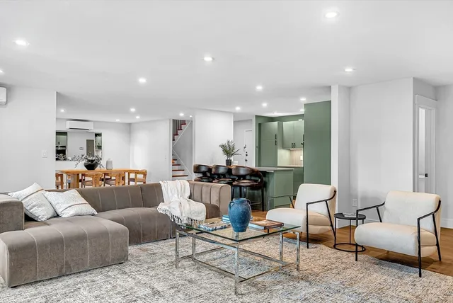 a living room with furniture and kitchen view