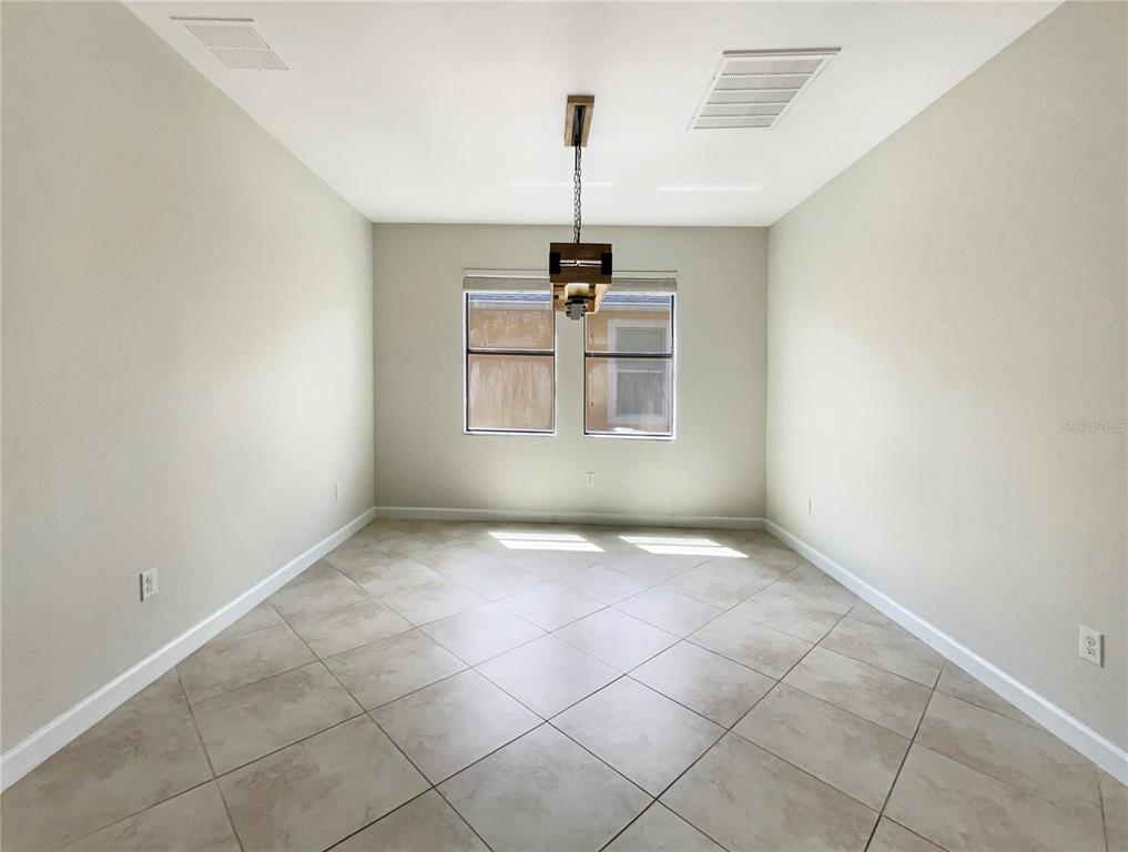 19491 Paddock View Drive Tampa, FL 33647 - Photo 13 of 28 an empty room with windows and ceiling fan