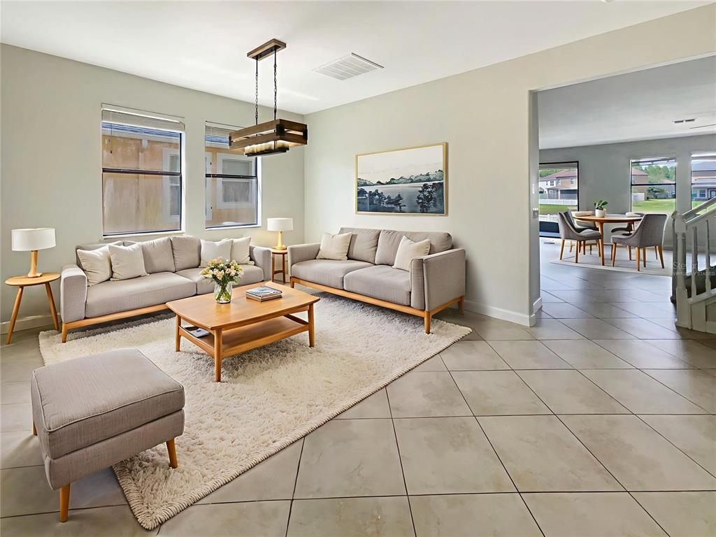 19491 Paddock View Drive Tampa, FL 33647 - Photo 2 of 28 a living room with furniture a dining table and a window