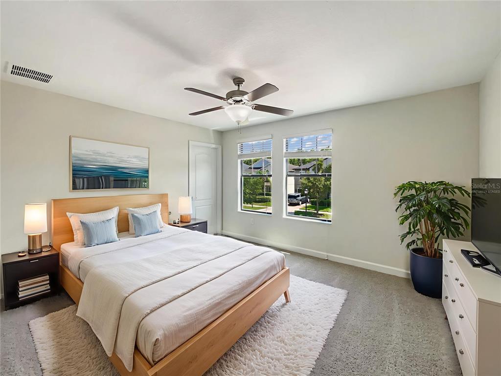 19491 Paddock View Drive Tampa, FL 33647 - Photo 4 of 28 a bedroom with a bed and a potted plant