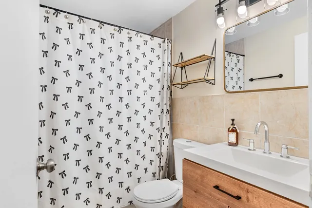 a bathroom with a sink toilet and shower