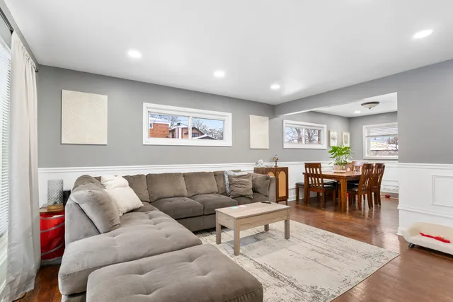 a living room with furniture and view of kitchen