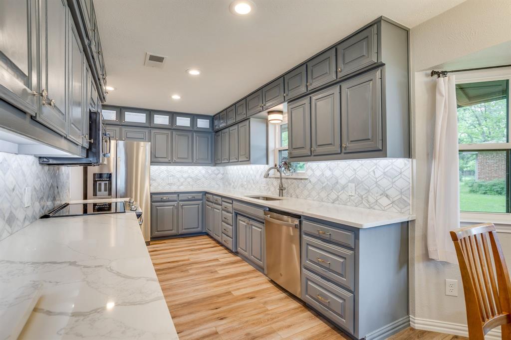 10814 Power Squadron Road Azle, TX 76020 - Photo 5 of 34 a kitchen with stainless steel appliances granite countertop a sink and cabinets