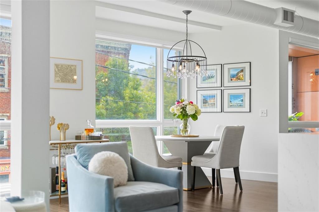 3725 Butler Street, Unit 304 Pittsburgh, PA 15201 - Photo 7 of 26 a dining room with furniture a chandelier and window