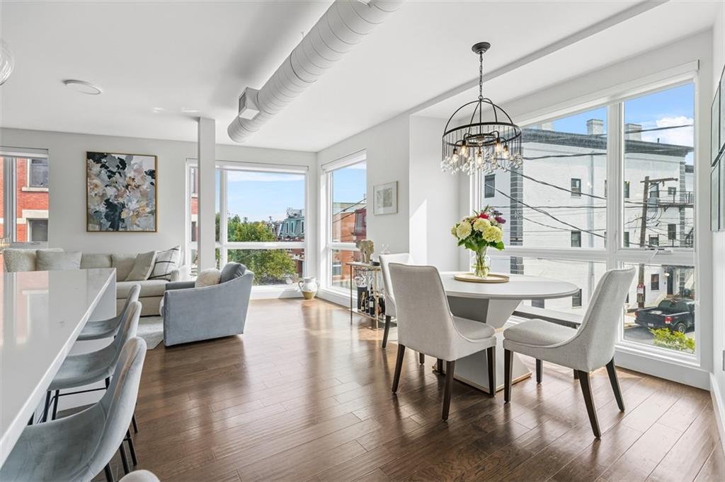 3725 Butler Street, Unit 304 Pittsburgh, PA 15201 - Photo 8 of 26 a view of a dining room with furniture window and wooden floor