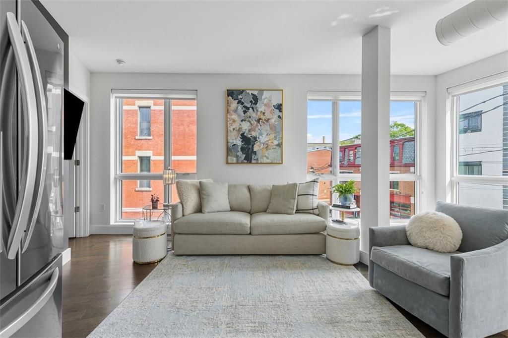 3725 Butler Street, Unit 304 Pittsburgh, PA 15201 - Photo 9 of 26 a living room with furniture and a large window