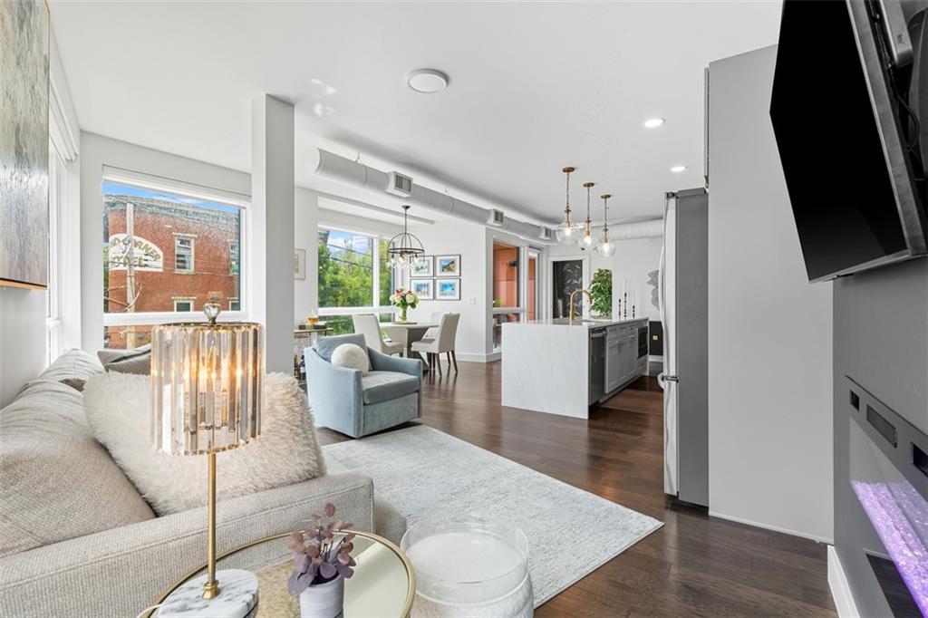 3725 Butler Street, Unit 304 Pittsburgh, PA 15201 - Photo 10 of 26 a living room with furniture and a flat screen tv