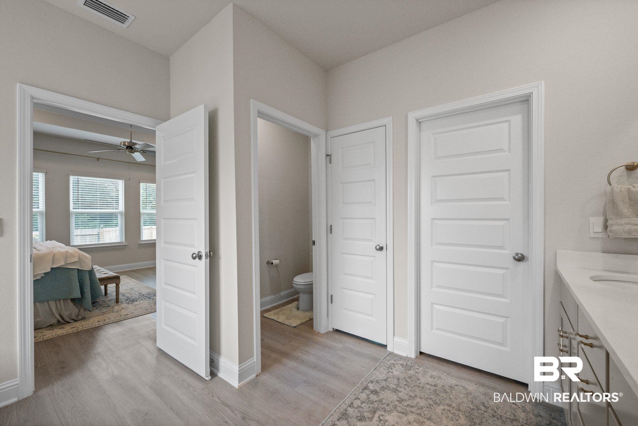 681 Calibre Street Fairhope, AL 36532 - Photo 36 of 56 Bathroom featuring vanity, toilet, wood-type flooring, and ceiling fan