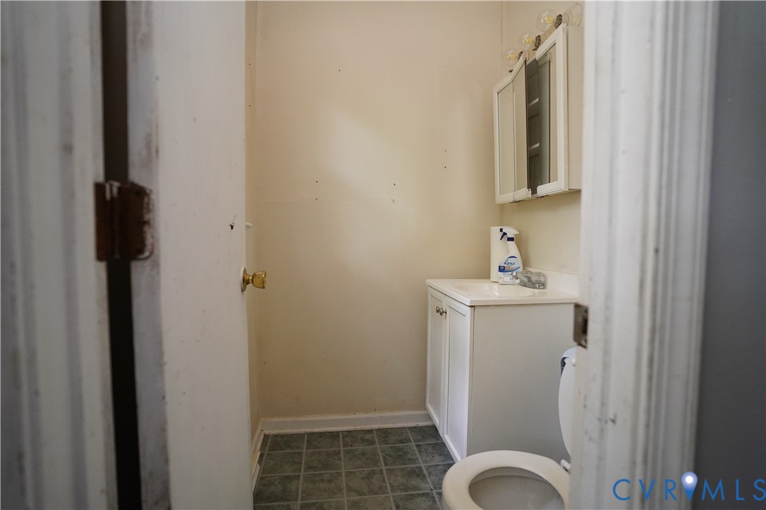 1439 Mahixon Road Manquin, VA 23106 - Photo 13 of 13 Half bathroom featuring vanity and tile patterned
