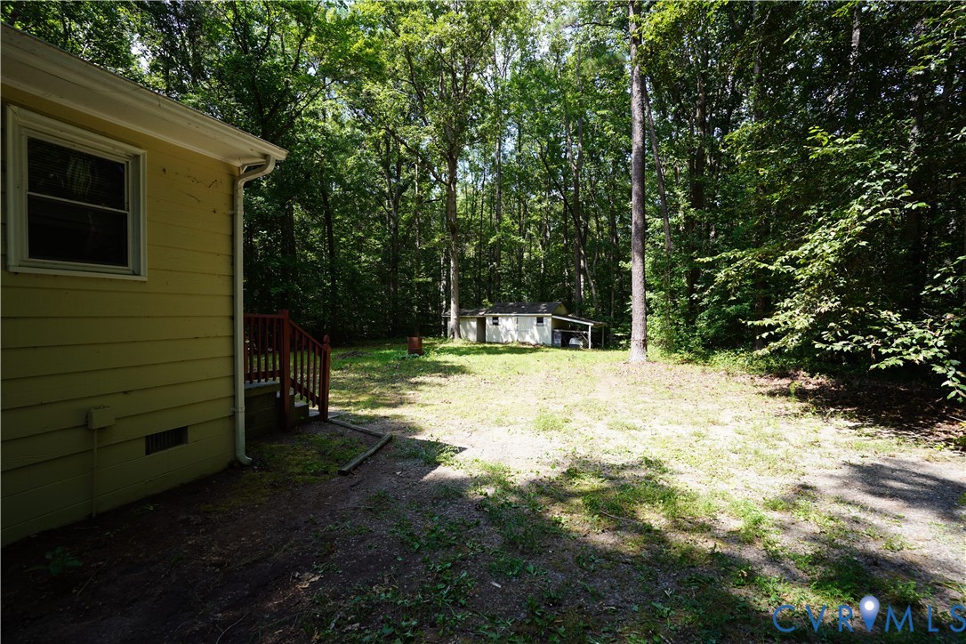 1439 Mahixon Road Manquin, VA 23106 - Photo 2 of 13 View of back yard and storage sheds (there are 2)