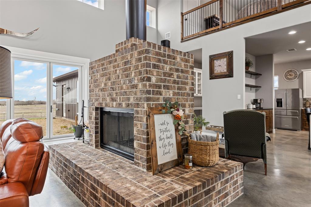 201 W Road Waxahachie, TX 75165 - Photo 15 of 40 a living room with furniture a fireplace and a table