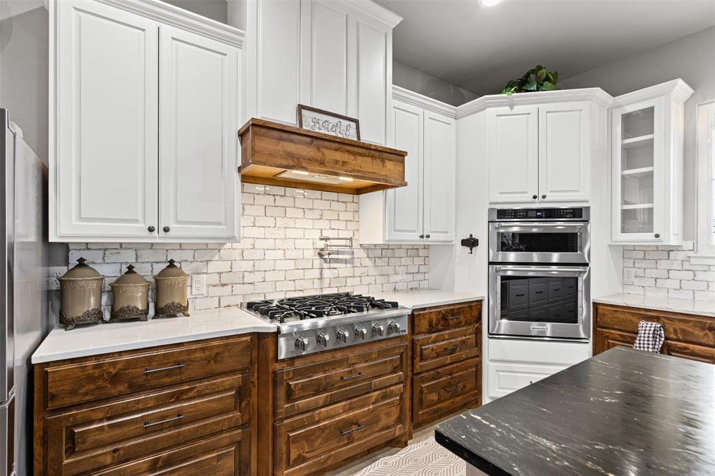 201 W Road Waxahachie, TX 75165 - Photo 2 of 40 a kitchen with granite countertop a stove and a refrigerator