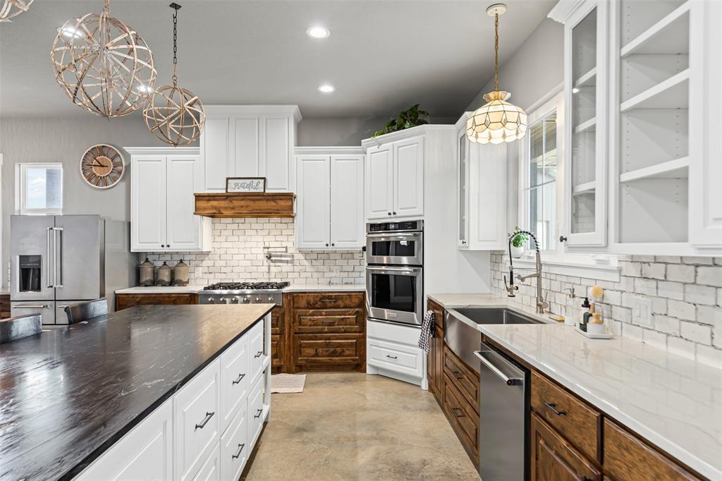 201 W Road Waxahachie, TX 75165 - Photo 6 of 40 a kitchen with kitchen island granite countertop a sink counter top space appliances and cabinets