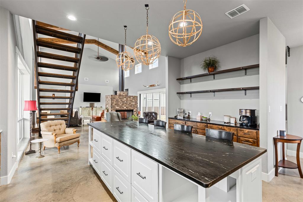 201 W Road Waxahachie, TX 75165 - Photo 8 of 40 a kitchen with stainless steel appliances granite countertop a sink a stove and a wooden floors