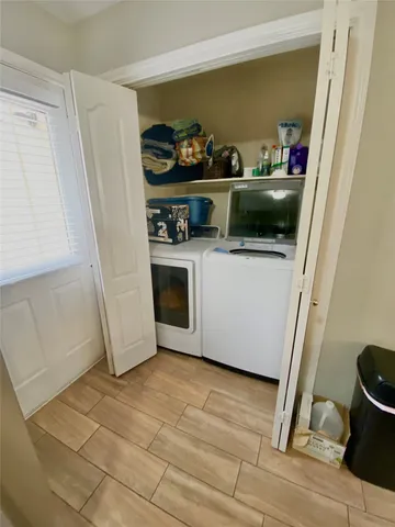 a large kitchen with a sink and washing machine