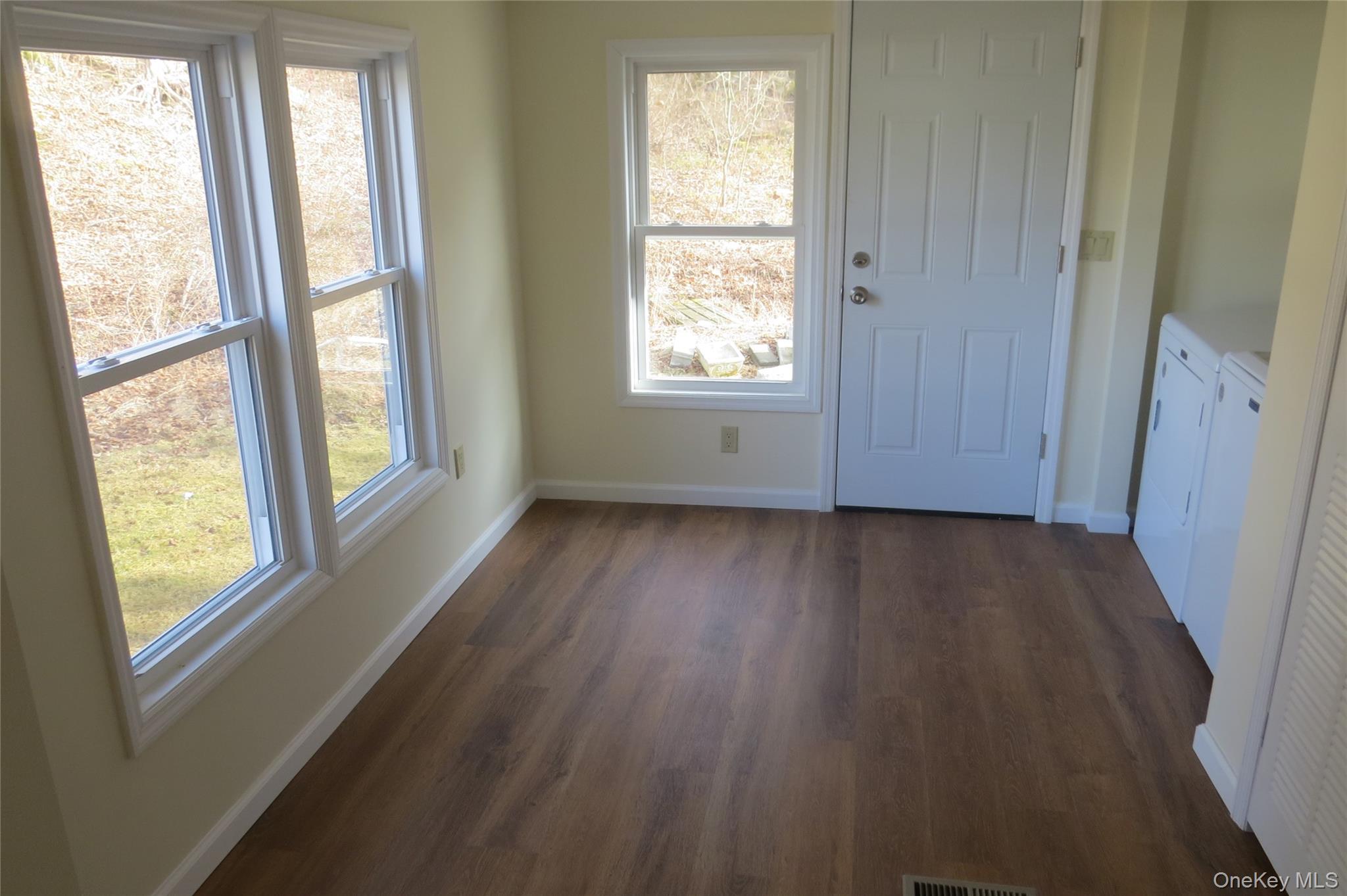 723 Beekman, Unit 64 Hopewell Junction, NY 12524 - Photo 11 of 28 a view of an empty room with wooden floor and a window