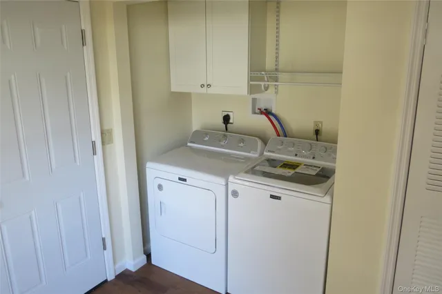 a view of a storage and utility room with dryer and washer