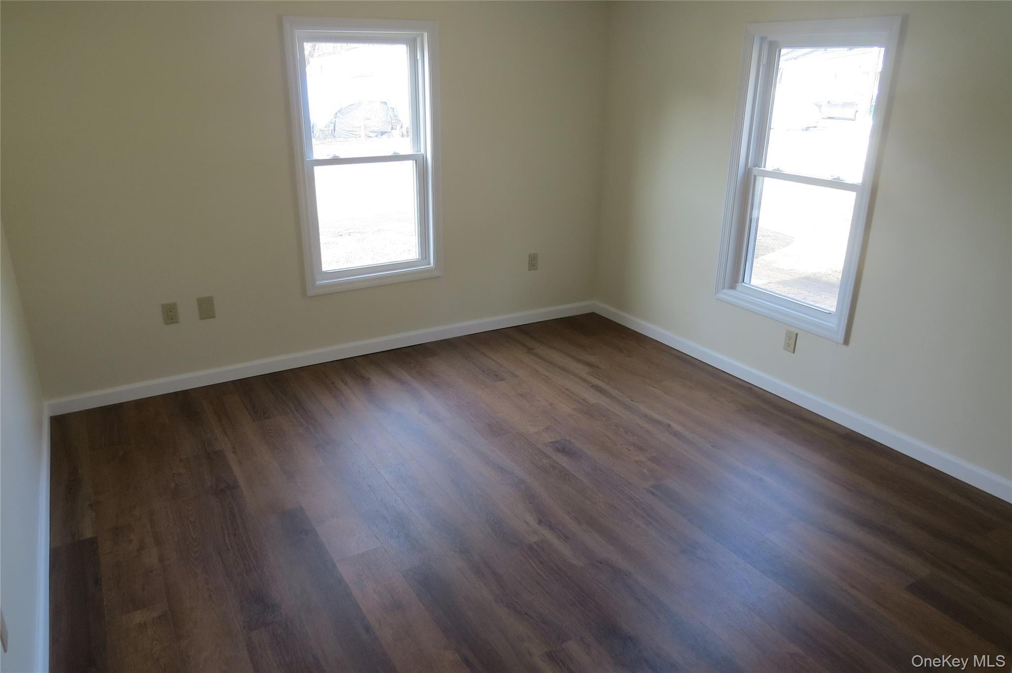 723 Beekman, Unit 64 Hopewell Junction, NY 12524 - Photo 26 of 28 an empty room with wooden floor and windows