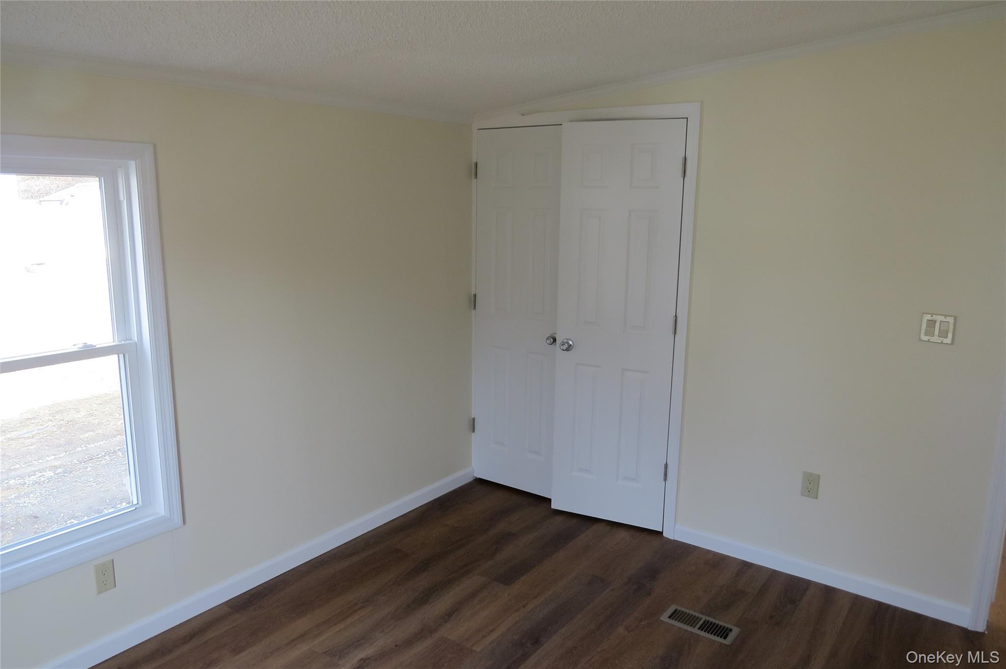 723 Beekman, Unit 64 Hopewell Junction, NY 12524 - Photo 27 of 28 an empty room with wooden floor and windows