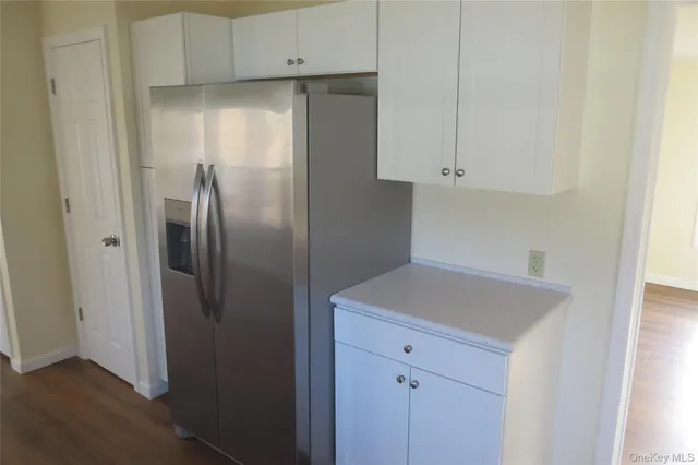 a kitchen with a refrigerator and cabinets