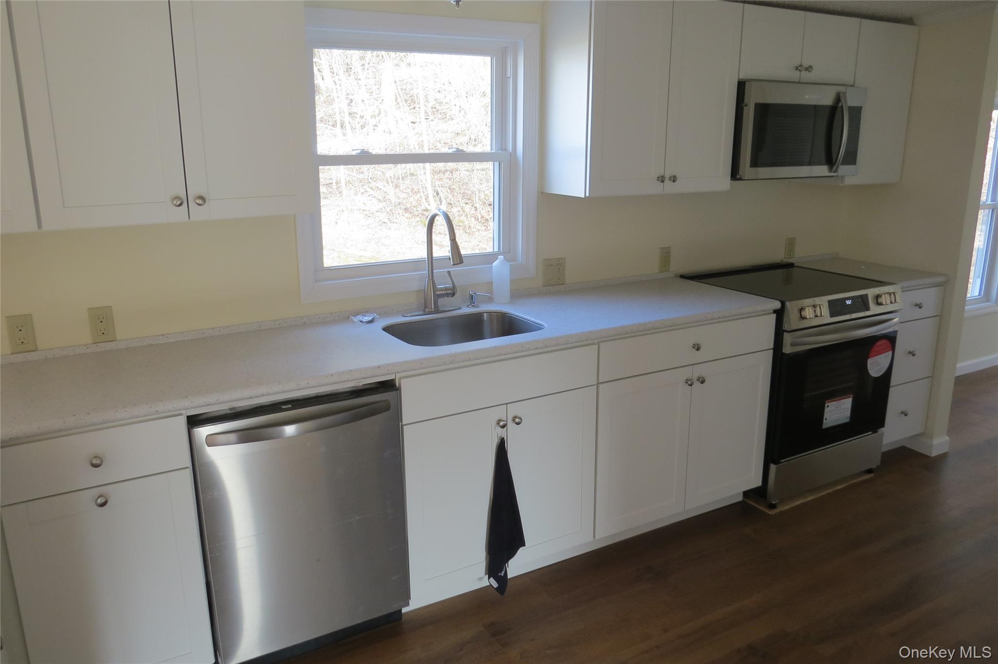 723 Beekman, Unit 64 Hopewell Junction, NY 12524 - Photo 8 of 28 a kitchen with stainless steel appliances granite countertop a sink a stove and a refrigerator
