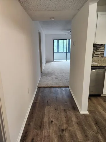 a view of hallway with wooden floor and stairs
