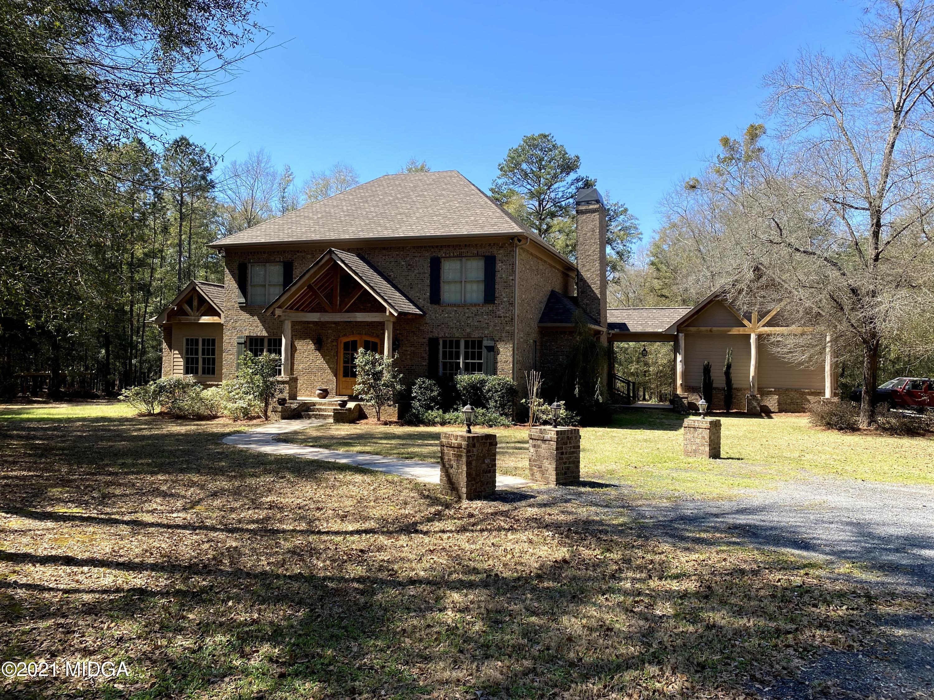 619 Harper Road Perry, GA 31069 - Photo 1 of 27 a front view of a house with a yard