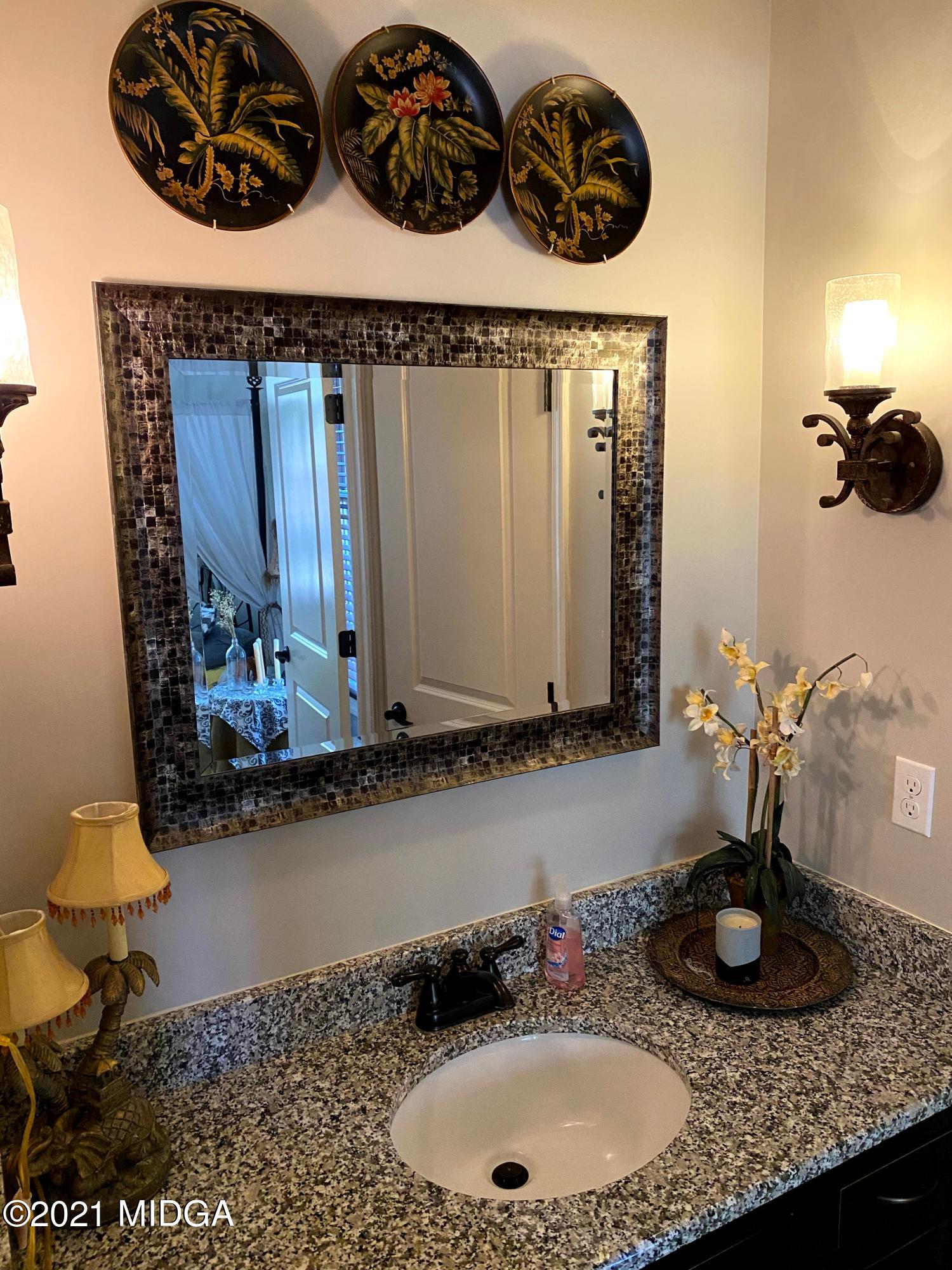 619 Harper Road Perry, GA 31069 - Photo 14 of 27 a bathroom with a granite countertop sink and a mirror