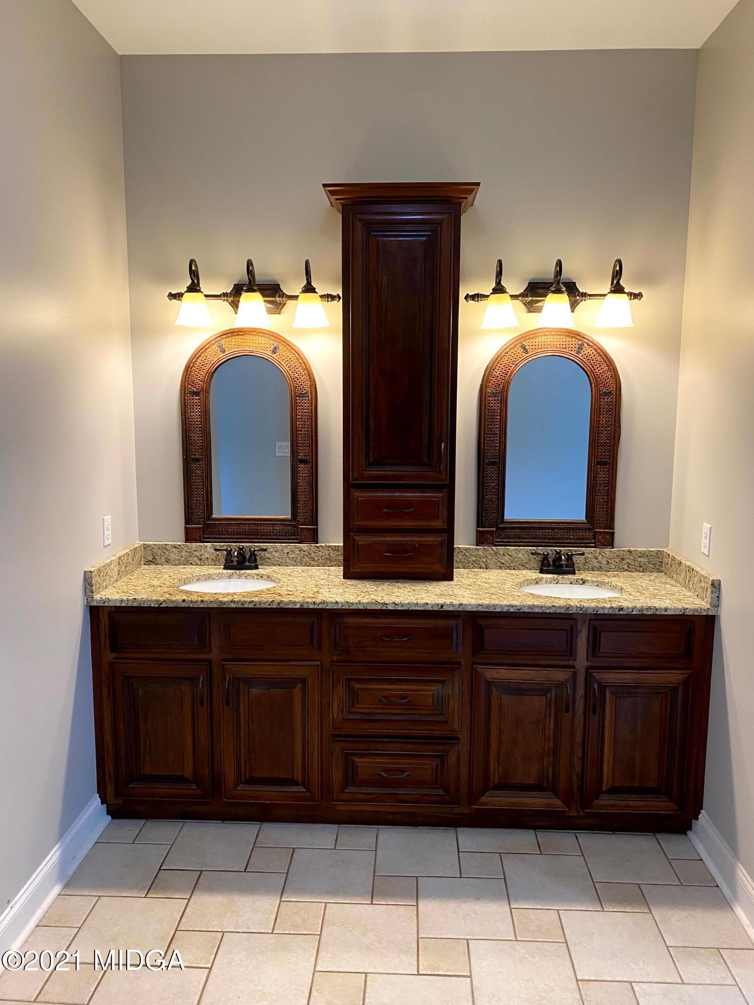 619 Harper Road Perry, GA 31069 - Photo 21 of 27 a bathroom with a granite countertop sink and a mirror