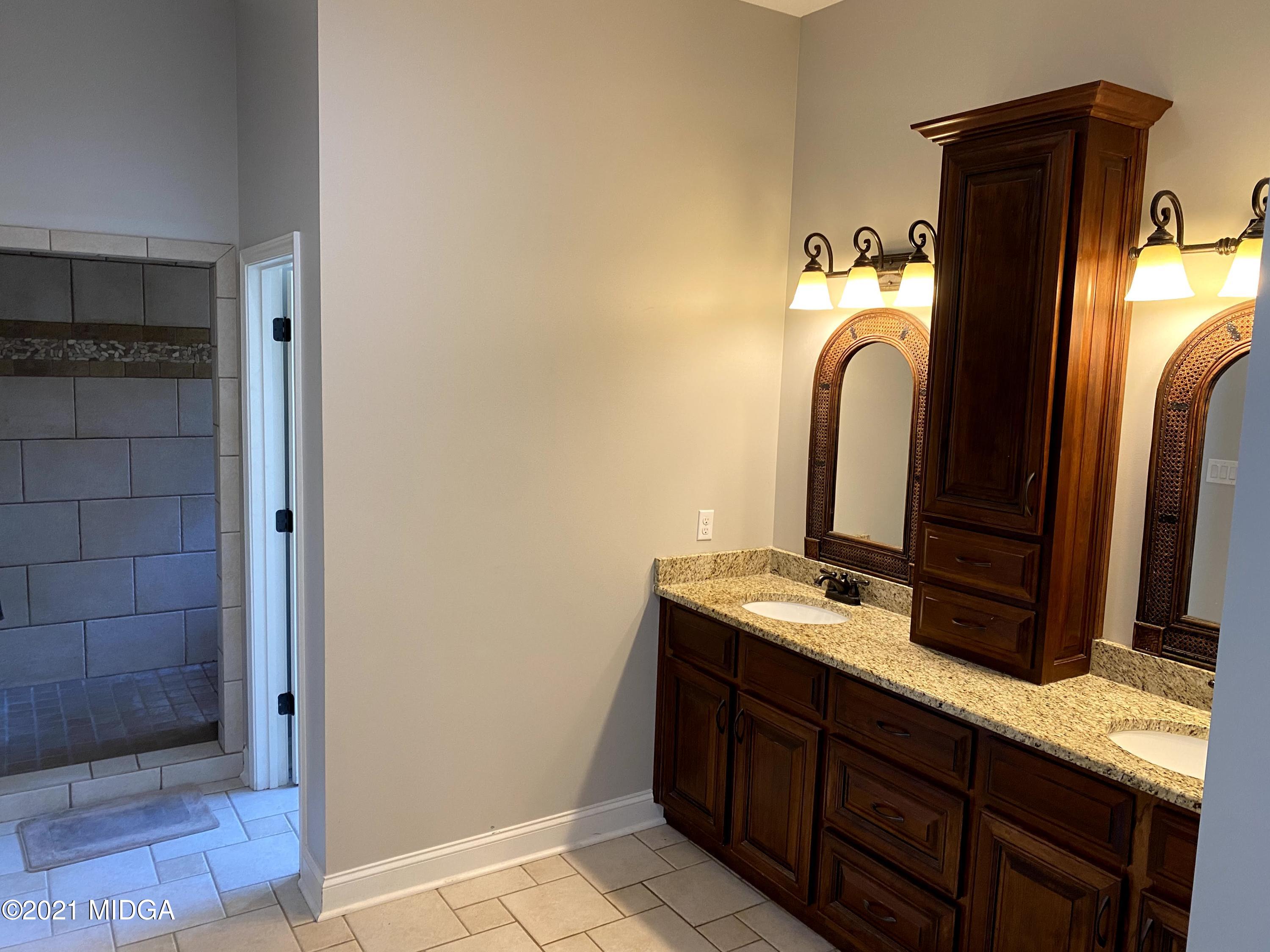 619 Harper Road Perry, GA 31069 - Photo 22 of 27 a bathroom with a sink and a mirror