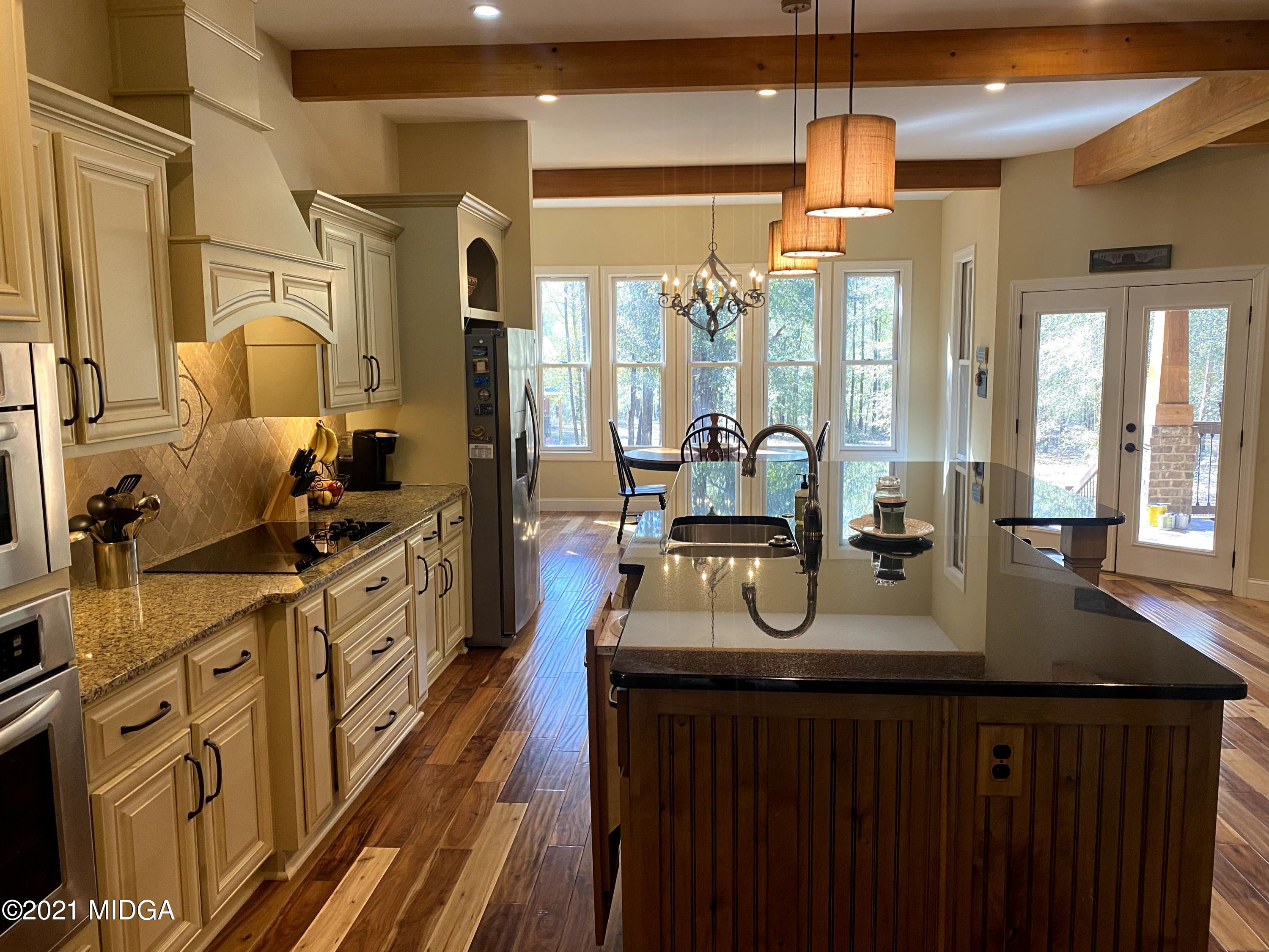 619 Harper Road Perry, GA 31069 - Photo 27 of 27 a kitchen with stainless steel appliances granite countertop a sink stove and cabinets