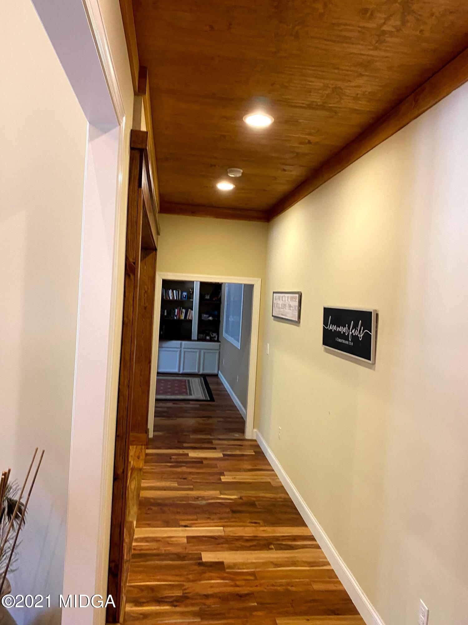 619 Harper Road Perry, GA 31069 - Photo 9 of 27 a view of a hallway with wooden floor and staircase